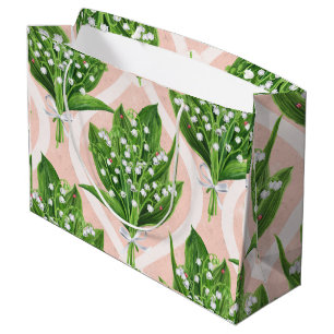 Bouquet of lilly of the valley flowers on pink large gift bag
