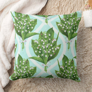 Bouquet of lily of the valley flowers on blue cushion