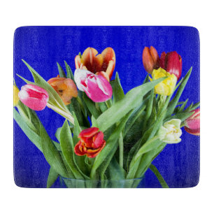 Bouquet of tulips on blue cutting board