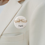 Bow beige cream name tag 6 cm round badge<br><div class="desc">A beige,  cream coloured background. Decorated with a large bow.  Personalise and add your name.   Black handwritten style script.</div>