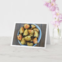 Bowl of Sliced Plum Fruit on Wooden Table