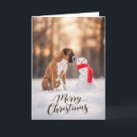 Boxer Dog Christmas Snowman Holiday Card<br><div class="desc">A heartwarming winter holiday scene featuring a Boxer dog sitting in fresh snow beside a cheerful little snowman wrapped in a bright red scarf. Soft golden winter light and gently falling snow create a peaceful seasonal moment that highlights the playful personality and loyal spirit Boxers are known for. Perfect for...</div>