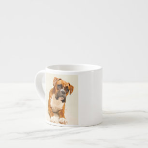 Boxer puppy on ivory cream backdrop. espresso cup