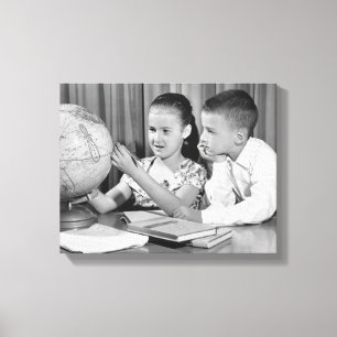 Boy and Girl Viewing Globe Canvas Print