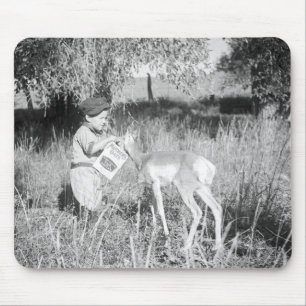 Boy feeding antelope mouse pad