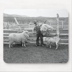 Boy holding up a bundle of wool mouse pad