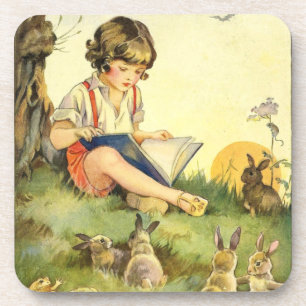 Boy reading under tree with rabbits coaster