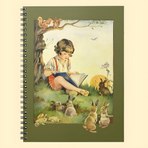 Boy reading under tree with rabbits spiral notebook