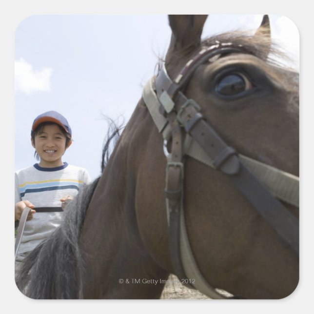 Boy riding a horse square sticker (Front)
