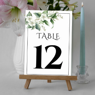 Branch with greenery and white flowers wedding table number