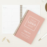 Branded Rose Gold Business Weekly Planner<br><div class="desc">A warm rose gold weekly planner designed for businesses to brand with their own custom logo, employee name, business name, slogan, location, and website. The soft blush tone paired with a clean framed logo placement and elegant script accents creates a boutique organisational tool for staff, clients, or corporate gifting. All...</div>
