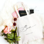 Bride Modern Elegant Script Wedding Custom Name Tote Bag<br><div class="desc">Bride Modern Elegant Script Typography Wedding Custom Name Tote Bag features the simple text "Bride" in an elegant modern black calligraphy script typography. Personalised with your custom name and wedding date. Perfect for the bride for a bridal shower or wedding day. Designed by Evco Studio www.zazzle.com/store/evcostudio</div>