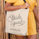 Bride Squad Modern Script Gold Wedding Name Tote Bag<br><div class="desc">This modern tote bag with a minimalist casual chic script calligraphy design reading BRIDE SQUAD as well the your custom name of your maid of honour or bridesmaid features clean lines to create a sleek and sophisticated appearance. The understated style with the little printed gold heart detail adds a touch...</div>