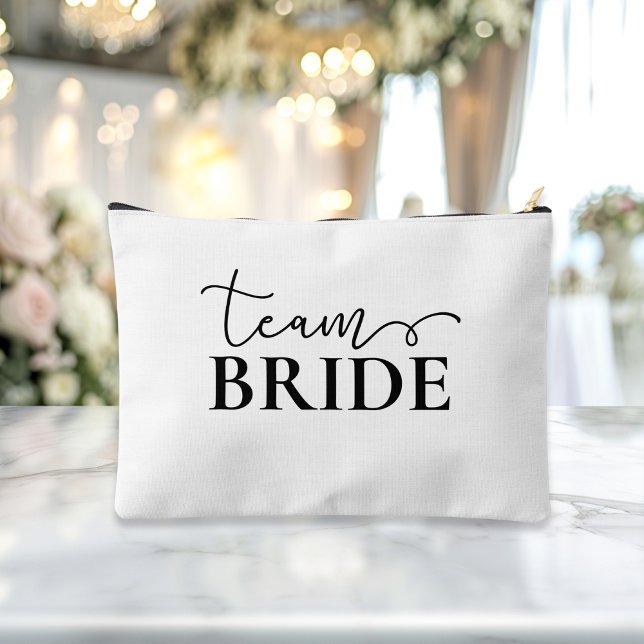 Bride - Team Bride! Gift Name  Accessory Pouch ("This Bride / Team Bride accessory and makeup bag showcases a sleek black script font with elegant s)