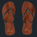 Bride Wedding Day Rustic Wood Look Beach Honeymoon Jandals<br><div class="desc">Rustic wood look bride flip flop thong sandals perfect for beach weddings- Reads Bride in elegant style, pastel pink letters at the bottom. Elegant, rich mahogany wood look woodgrain pattern background. Note: Wood is printed image. Rustic wedding favours for bridal party members. Just change text templates to create your own...</div>