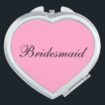 Bridesmaid Compact Mirror<br><div class="desc">Compact mirror shown in a heart shape with a pink background colour with Bridesmaid text in black.
Customise this item or buy as is.</div>