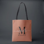 Bridesmaid Gift Gold Black Monogram Terracotta Tote Bag<br><div class="desc">This Bridesmaid tote bag features a handwritten white and black script typography monogram with swashes on a terracotta background. Present your bridesmaids with a tote for carrying items the day of the wedding,  and traditionally presented at the rehearsal dinner or before.</div>