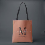 Bridesmaid Gift Gold Black Monogram Terracotta Tote Bag<br><div class="desc">This Bridesmaid tote bag features a handwritten white and black script typography monogram with swashes on a terracotta background. Present your bridesmaids with a tote for carrying items the day of the wedding,  and traditionally presented at the rehearsal dinner or before.</div>