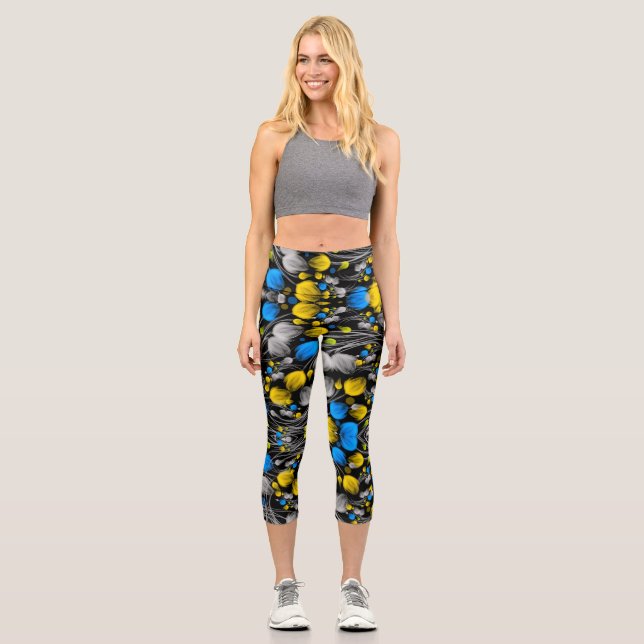 Bright abstract floral pattern on black background capri leggings (Front)