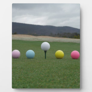 bright coloured Golf Balls on a mountain Plaque