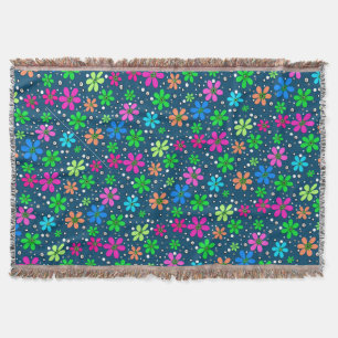 Bright multi-coloured chamomile flowers on a blue  throw blanket