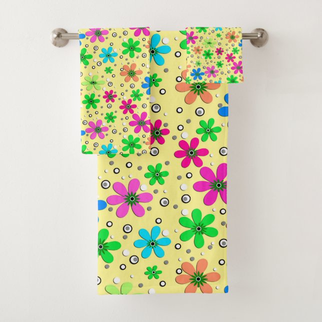Bright multi-coloured chamomile flowers on a yello bath towel set (Insitu)