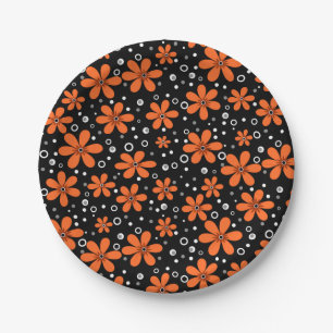 Bright orange flowers on a black background with w paper plate