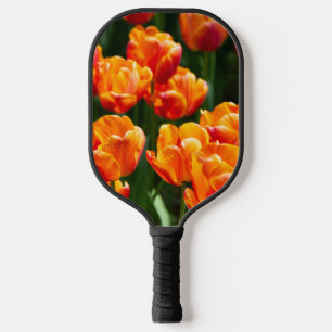 Bright orange tulips in the park   pickleball paddle
