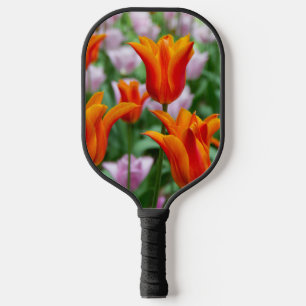 Bright orange tulips in the park pickleball paddle