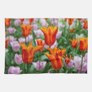 Bright orange tulips in the park tea towel