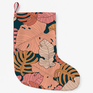 Bright pink, orange, yellow leaves of monstera and small christmas stocking