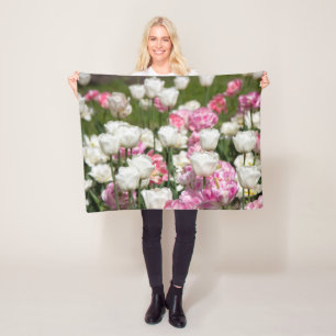 Bright white and pink tulips on a sunny day fleece blanket