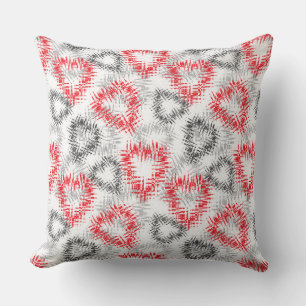 Broken hearts in red and gray on white cushion