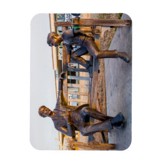 Bronze statue of young and older talking magnet