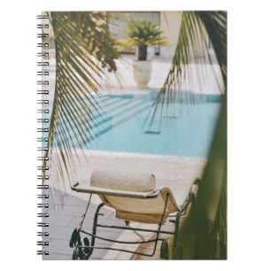 Brown and black armchair beside swimming pool in t notebook