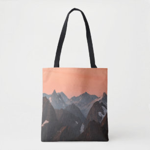 BROWN AND WHITE MOUNTAINS UNDER ORANGE SKY TOTE BAG