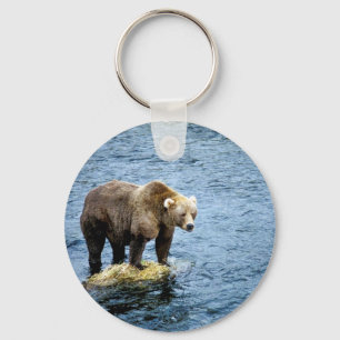 Brown bear on rock in river key ring