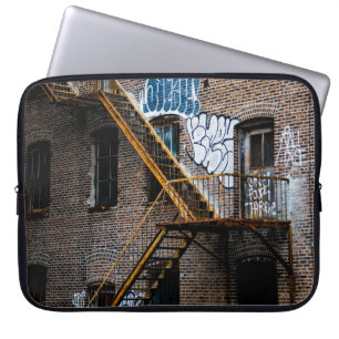 BROWN BRICK BUILDING WITH YELLOW METAL LADDER LAPTOP SLEEVE