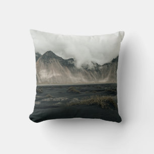 BROWN GRASS NEAR BODY OF WATER AND MOUNTAIN CUSHION
