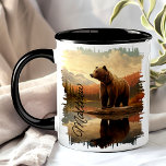Brown Grizzly Bear Lake Reflection Mug<br><div class="desc">Enjoy your favourite beverage with the Brown Grizzly Bear Lake Reflection Mug. This unique mug features a stunning design of a grizzly bear by a tranquil lake, with mountains and forests reflected in the water. Customised with your name, it adds a special touch that makes it uniquely yours. Perfect for...</div>