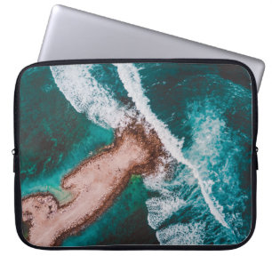 BROWN ISLAND SURROUNDED BY SEA WATER DURING DAYTIM LAPTOP SLEEVE