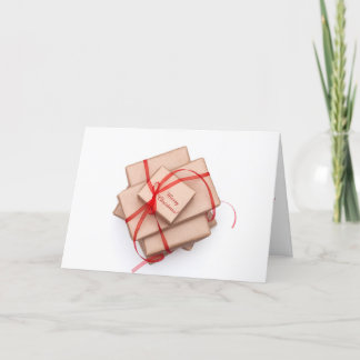 Brown paper packages tied with red ribbon holiday card