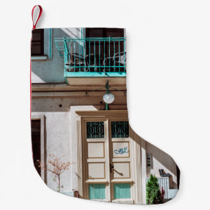 Brown wooden door on white concrete building small christmas stocking