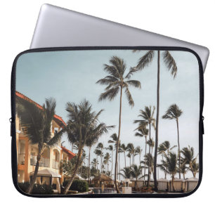 Brown wooden lounge chairs near pool surrounded by laptop sleeve