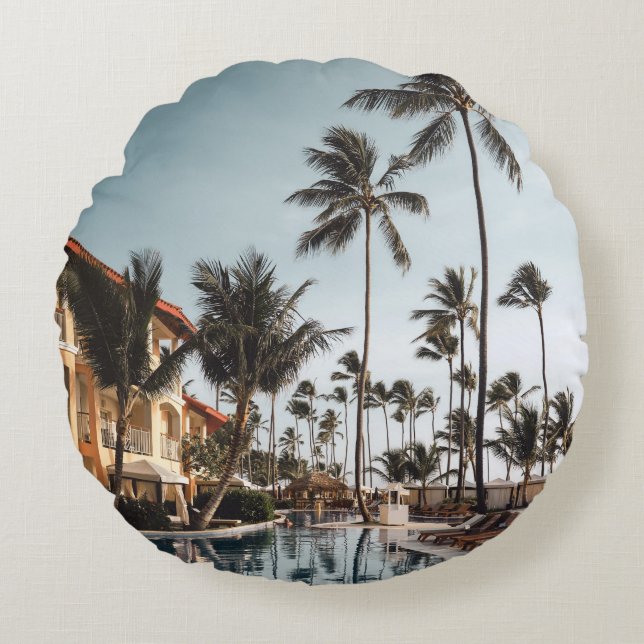 Brown wooden lounge chairs near pool surrounded by round cushion (Front)