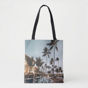 Brown wooden lounge chairs near pool surrounded by tote bag