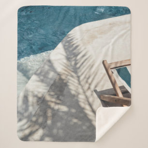 Brown wooden lounger near body of water sherpa blanket