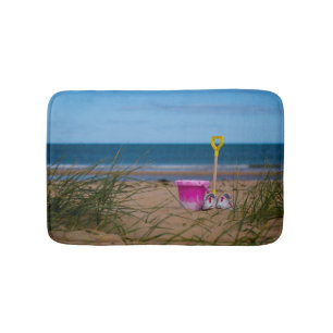 Bucket and spade on beach Bath mat