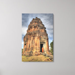 Buddhist monk standing in doorway of temple canvas print