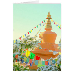 Buddhist stupa with prayer flags in snow